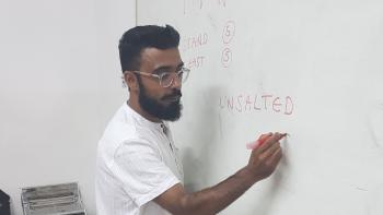 A man writing on a whiteboard