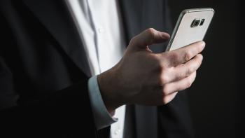 A hand using a mobile phone
