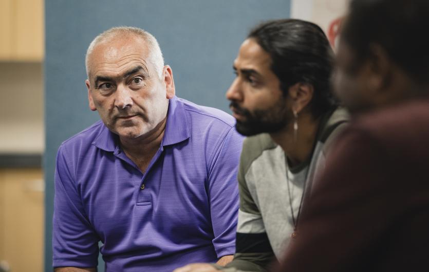 Therapy & Courses Men at a support group meeting