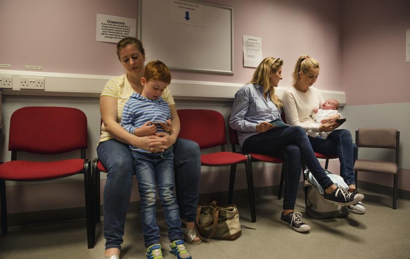 Resources for Health Professionals Mother with son in a clinic waiting room; therapist talking to another mother with a baby
