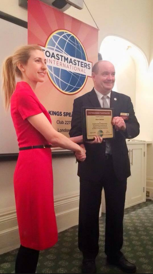 Brian accepting a Toastmasters award